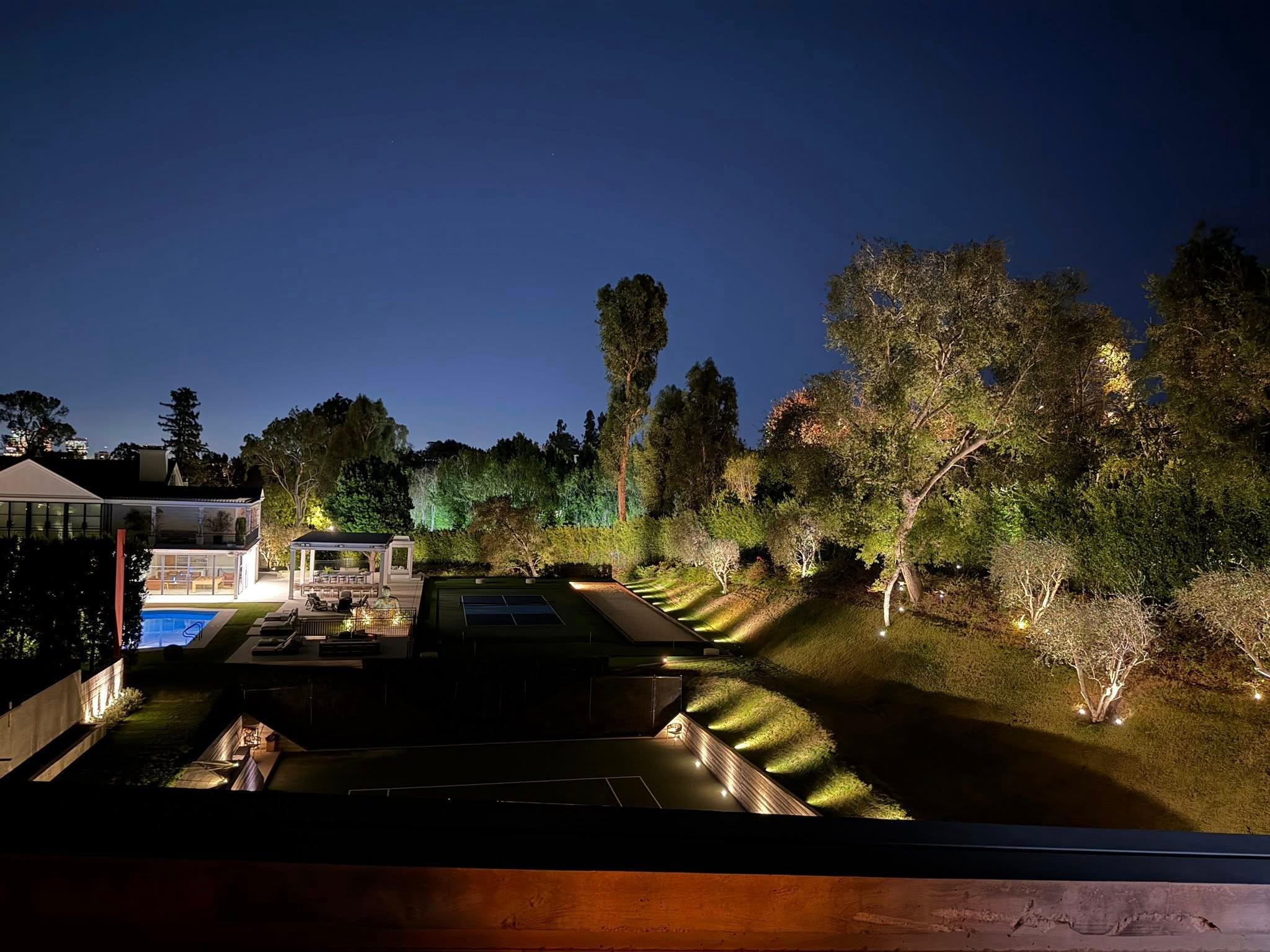 Illuminated luxury estate courtyard at night